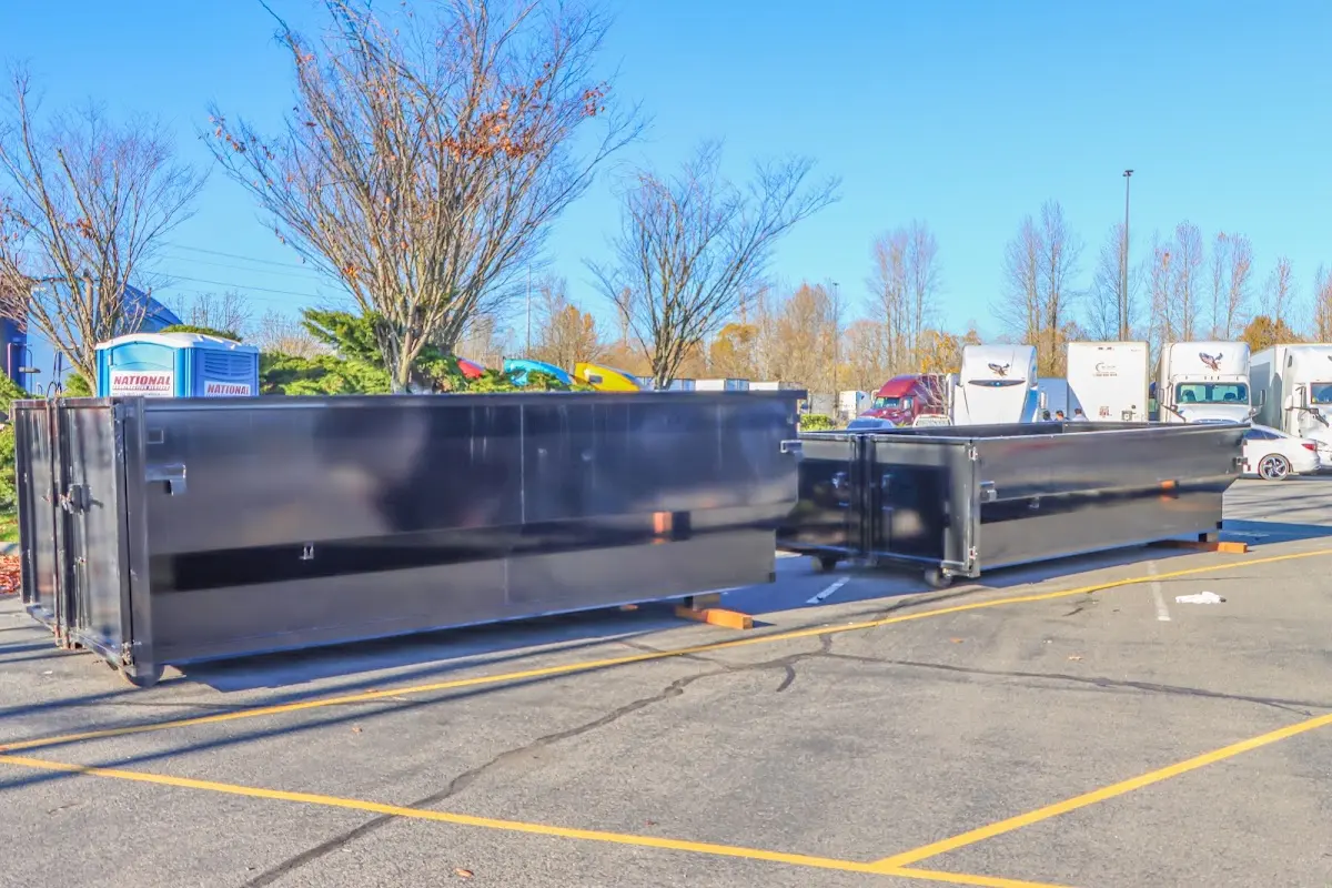 Professional dumpster rental service with roll-off container on residential driveway in Delran